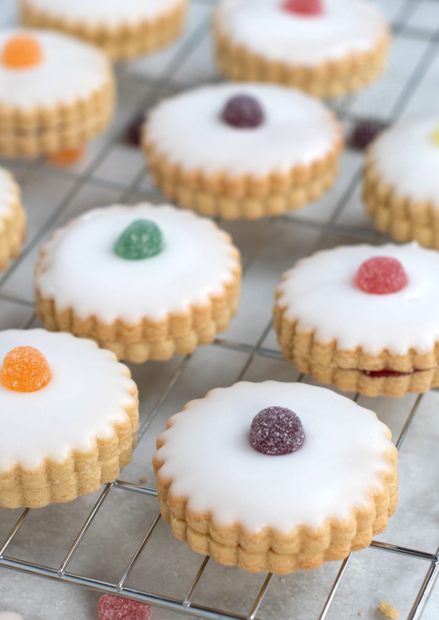Empire Biscuits recipe. Shortcake biscuits, sandwiched with jam, topped with icing and a sweetie or cherry.