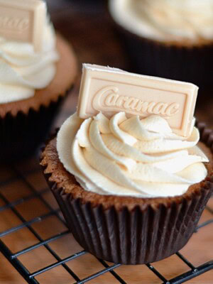 Caramac Cupcakes. Caramel white chooclate cupcakes, topped with a caramac buttercream and square of chocolate.