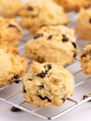 Close-up of golden Rock Bun with raisins, sultanas, currants and mixed fruit, on a cooling rack.