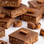 Homemade Mars Bar Slice with a chocolate rice crispy base, topped with smooth milk chocolate and pieces of Mars Bar.