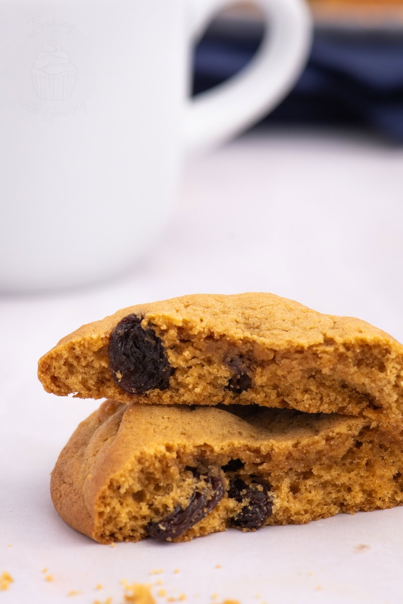 Close-up of Coffee Bun broken in half to show soft texture and sultanas inside.