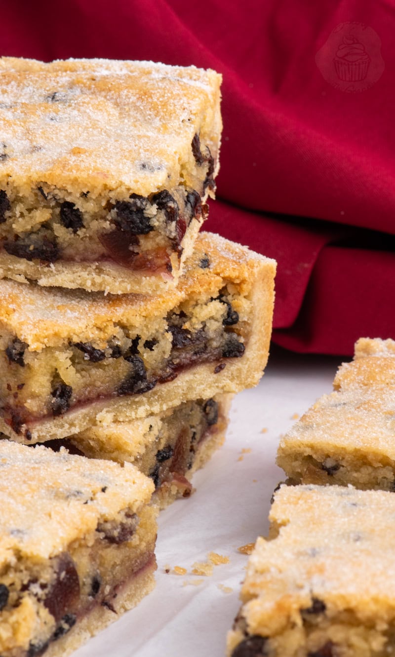 Stacked squares of Paradise Slice showing the rich fruit filling and golden shortcrust pastry base.