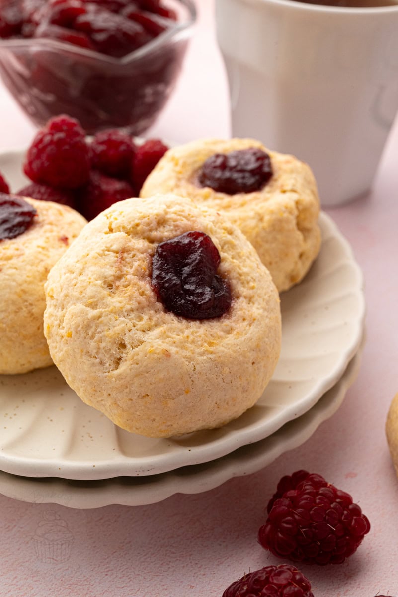 Close-up of soft British rasp buns with golden tops and raspberry jam filling.