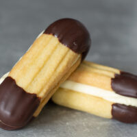 Recipe for easy Viennese biscuits. Buttery biscuits, dipped in chocolate and sandwiched with buttercream.
