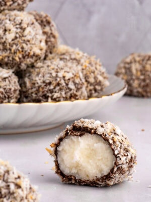 Scottish Macaroon cut in half on a plate, revealing the creamy potato fondant centre with chocolate and coconut coating.