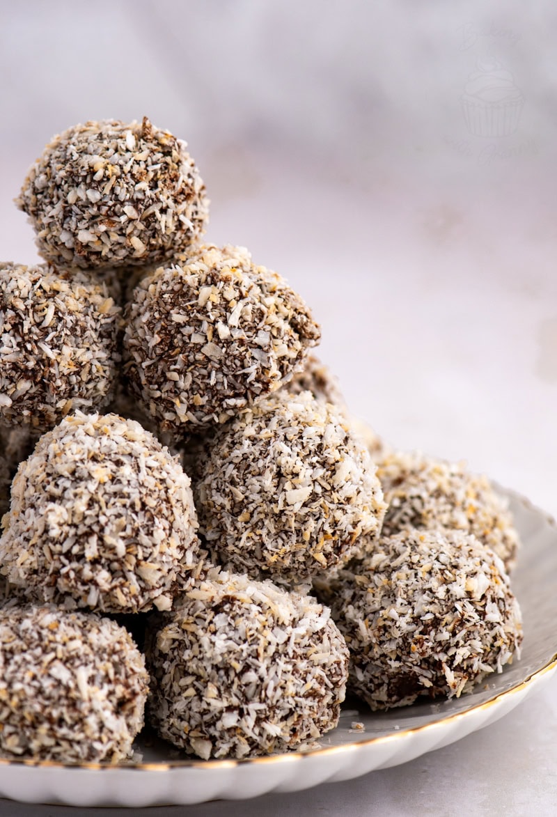 Plate stacked high with homemade Scottish Macaroons, coated in chocolate and coconut.