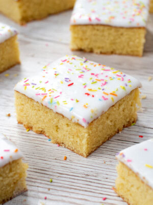 School Cake recipe by Baking with Granny. Sponge cake with white icing and rainbow sprinkles.