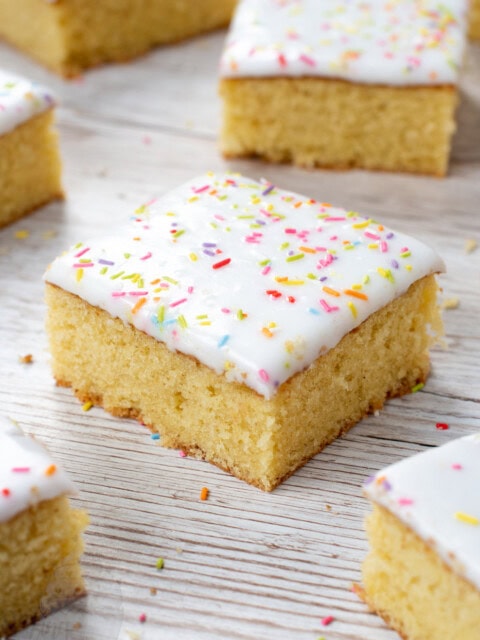 School Cake recipe by Baking with Granny. Sponge cake with white icing and rainbow sprinkles.