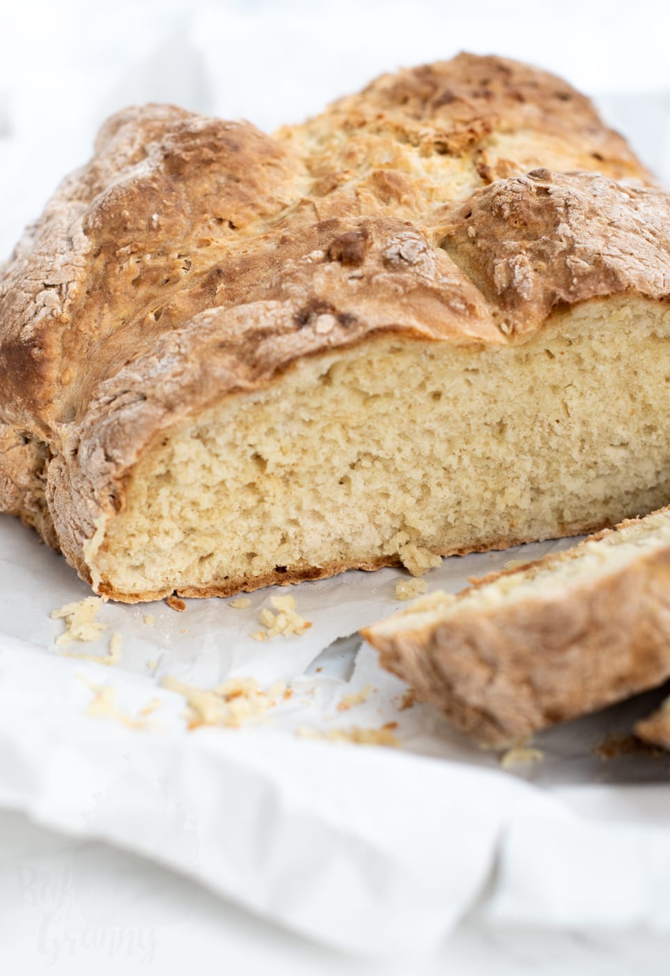 Close-up of sliced Irish soda bread loaf showing the soft interior and golden crust from this traditional soda bread recipe.