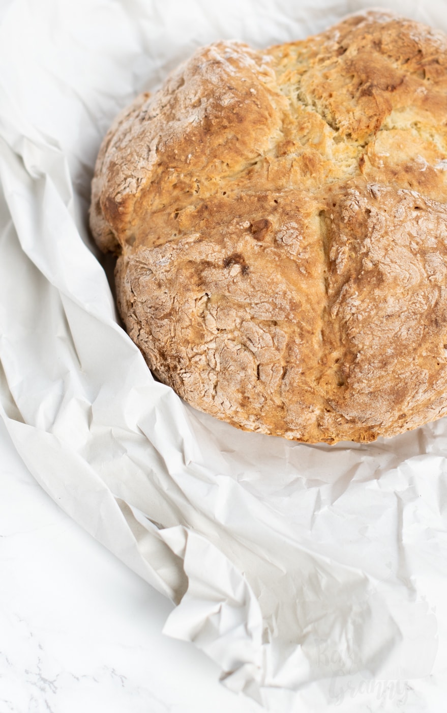 Rustic homemade Irish soda bread loaf baked with a cross on top, a classic traditional soda bread often enjoyed around St Patrick’s Day.