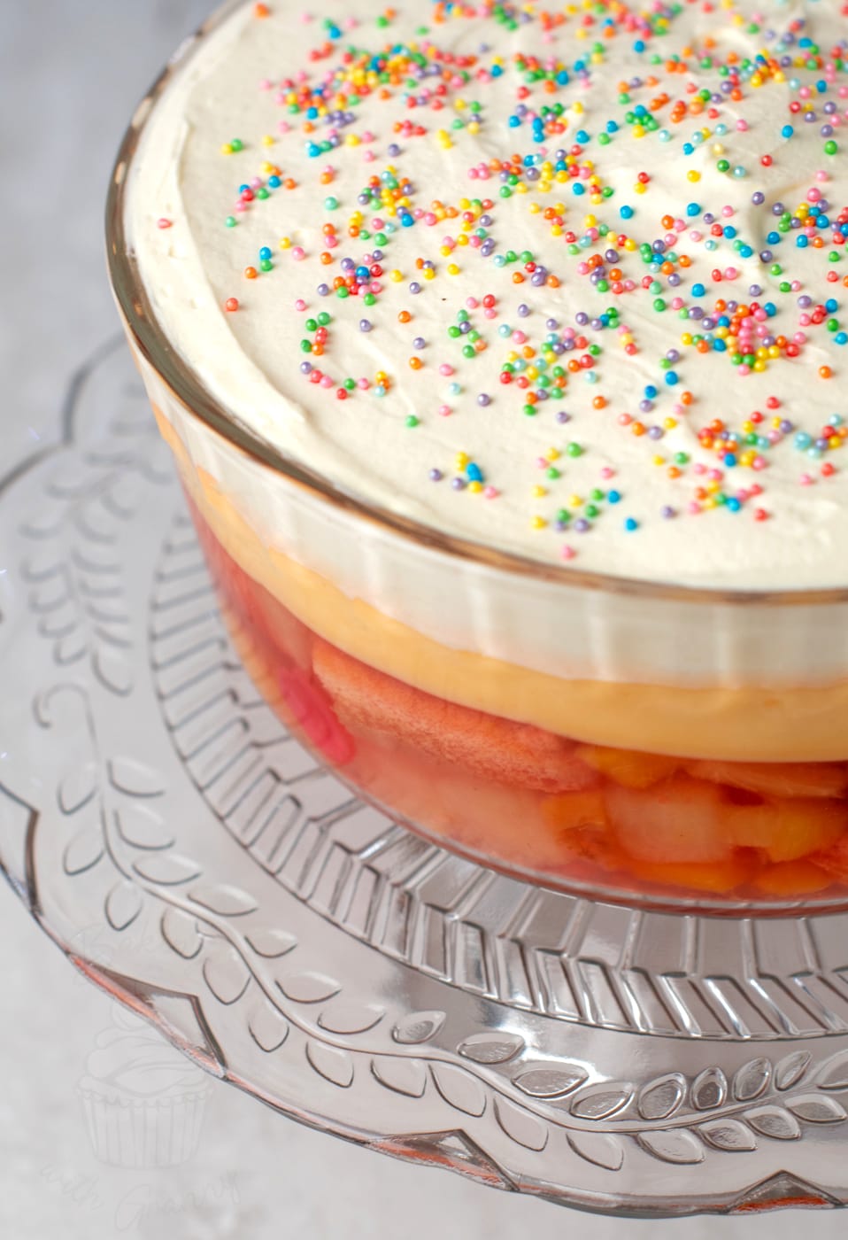 Christmas trifle recipe from Baking with Granny. Jelly, sponge and fruit base, with instant custard layer, topped with double cream and sprinkles.