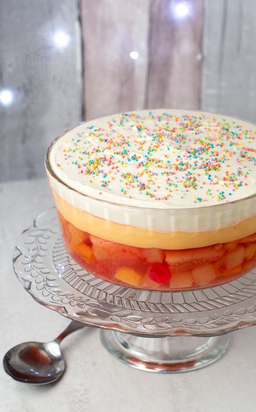 Classic easy trifle recipe. Strawberry jelly, with sponges and fruit cocktail. Topped with a layer of Birds custard and fresh cream. Finished with a sprinkle of hundreds and thousands.