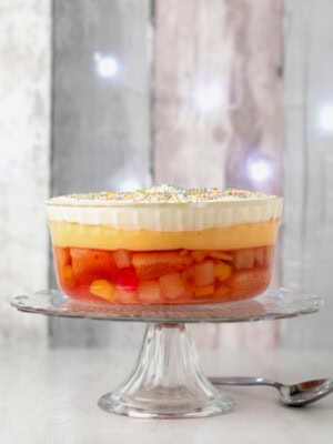Easy trifle made to traditional Scottish recipe, featuring fruit cocktail, jelly, custard, cream and sprinkles.
