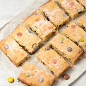 Polka Dot Slice recipe from Baking with Granny. Easy tray bake cake for kids, made with coconut and rainbow chocolate drops (such as Smarties or M&Ms).
