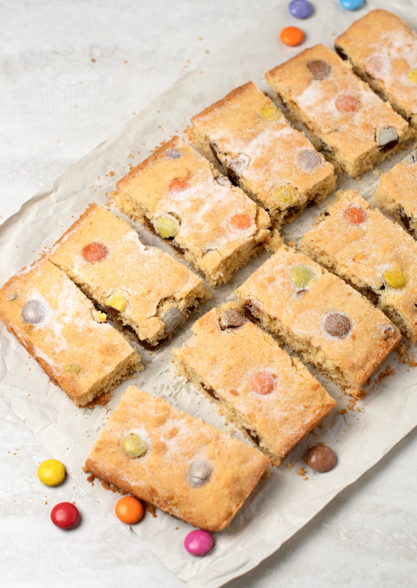Polka Dot Slice recipe from Baking with Granny. Easy tray bake cake for kids, made with coconut and rainbow chocolate drops (such as Smarties or M&Ms).