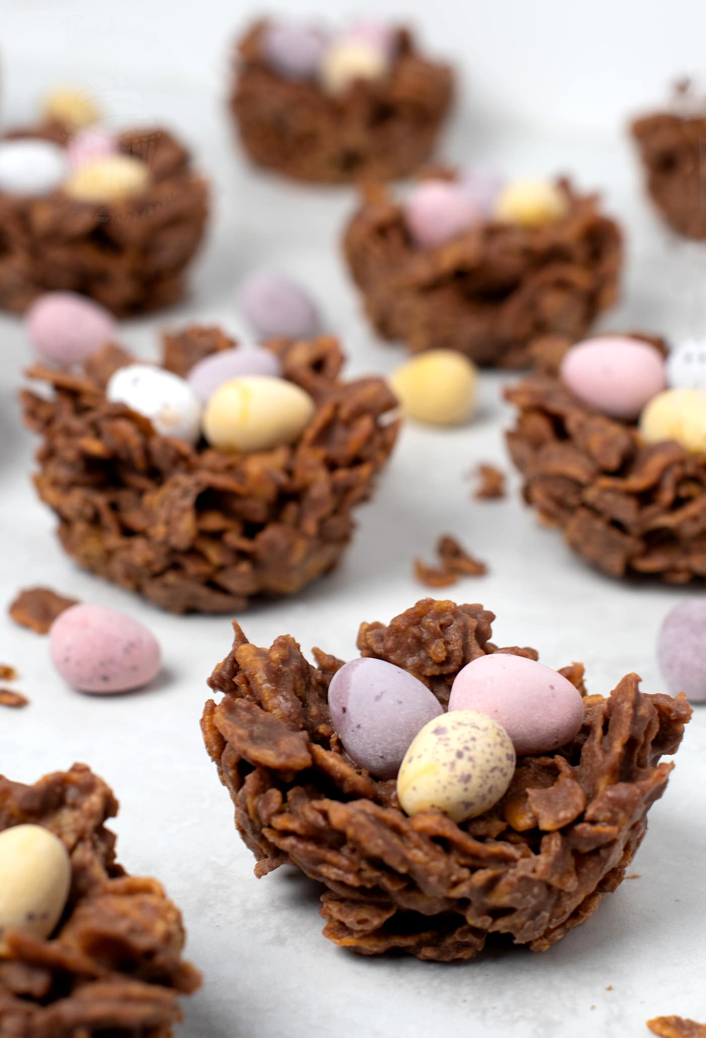 Close-up of chocolate Easter nest with cornflakes and mini eggs.