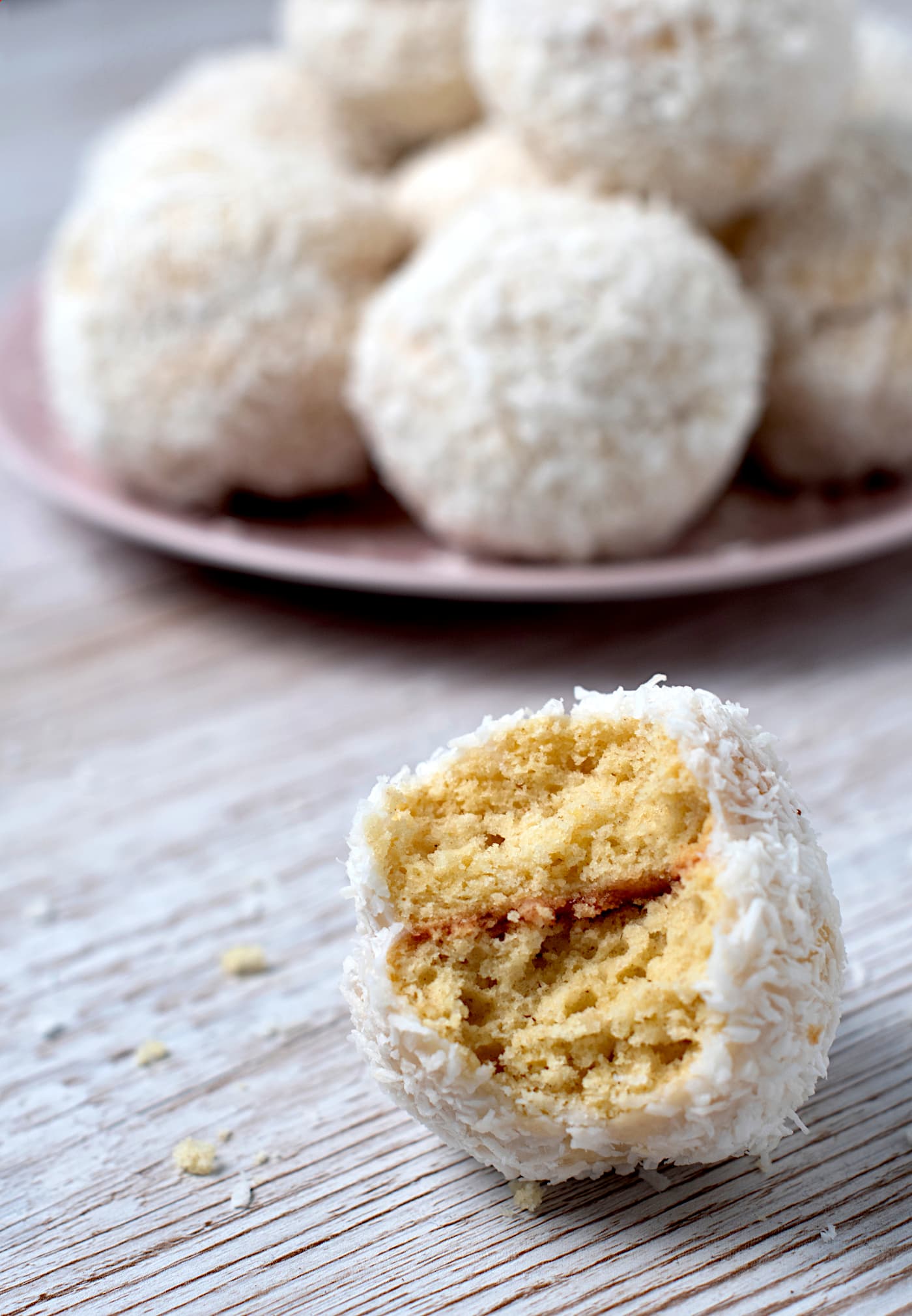 Homemade Scottish Snowball with jam filling inside, coated in icing and desiccated coconut.