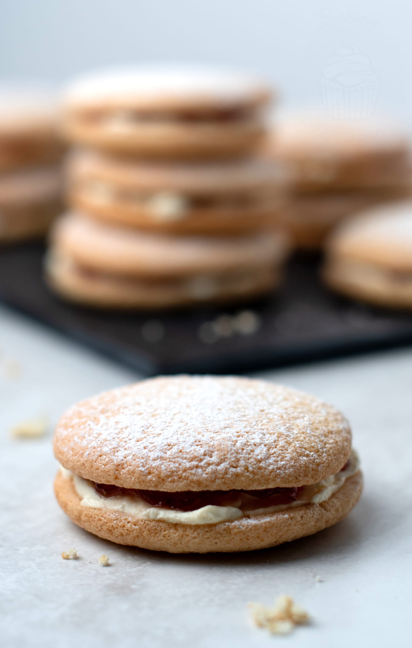 Sponge Drop close up, with the jam and cream filling being visible, and the icing sugar dusting on the top.