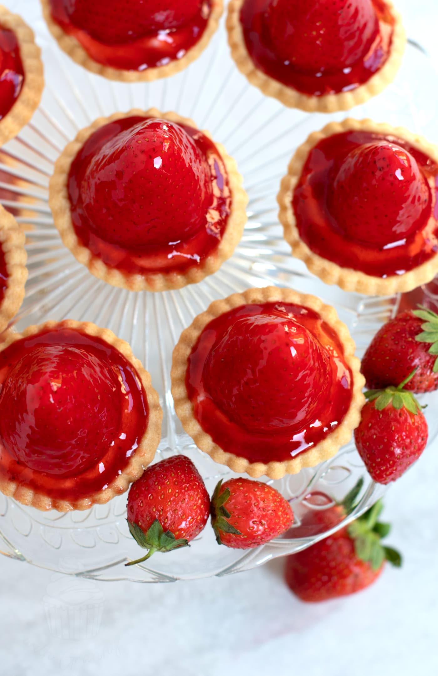Lots of traditional Strawberry Tarts, made to a Scottish recipe, with fresh pastry, fresh cream and home made strawberry sauce.