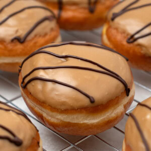 Fudge doughnuts recipe. Soft doughy buns, filled with delicious custard and topped with freshly made sweet fudge icing.