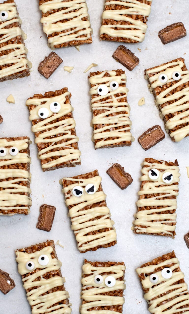 Mummy Mars Bar Slices decorated with white chocolate bandages and edible eyes.