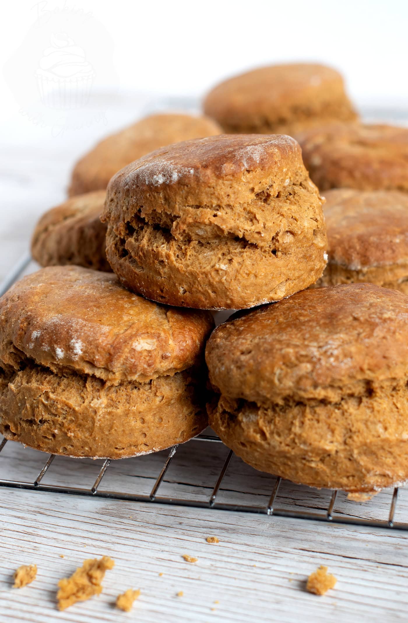 Freshly baked treacle scones with golden tops on a cooling rack.