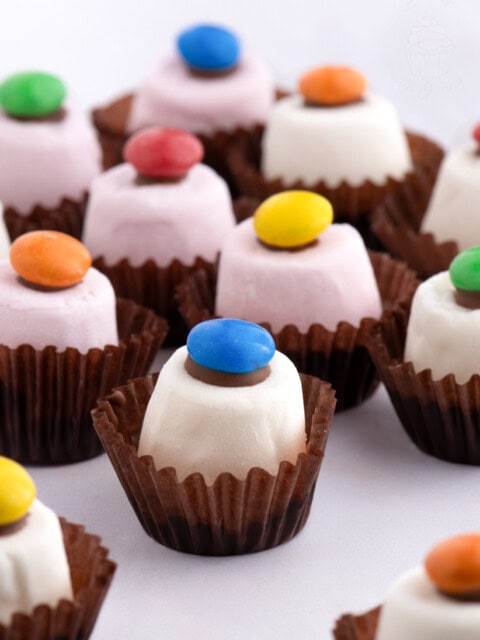 Assortment of Marshmallow Top Hats with chocolate bases and colourful smarties, a nostalgic Scottish party treat.