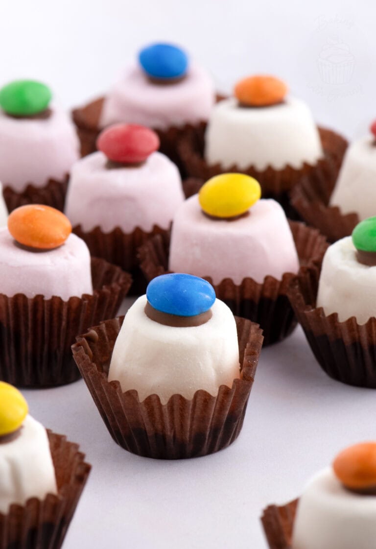 Assortment of Marshmallow Top Hats with chocolate bases and colourful smarties, a nostalgic Scottish party treat.