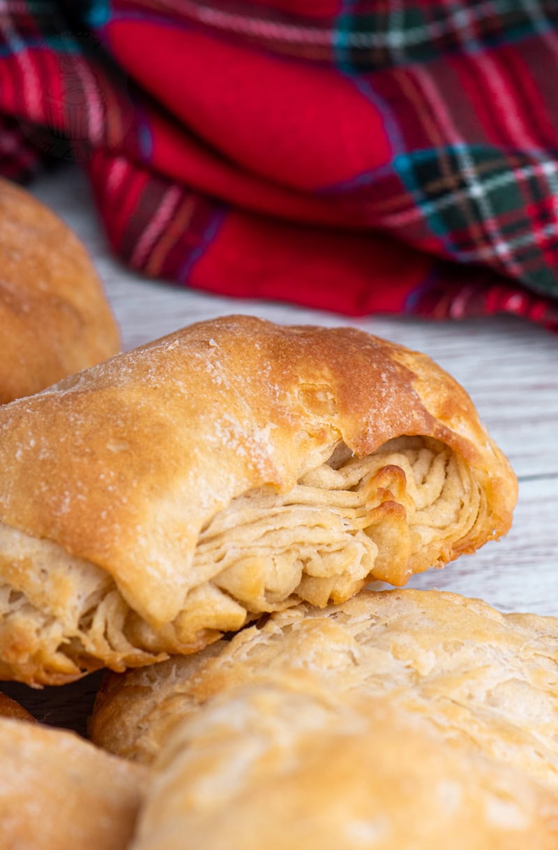 Freshly baked buttery with crisp golden crust and visible folded layers.