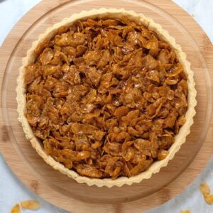 Cornflake tart with jam filling and sticky golden cornflake topping.