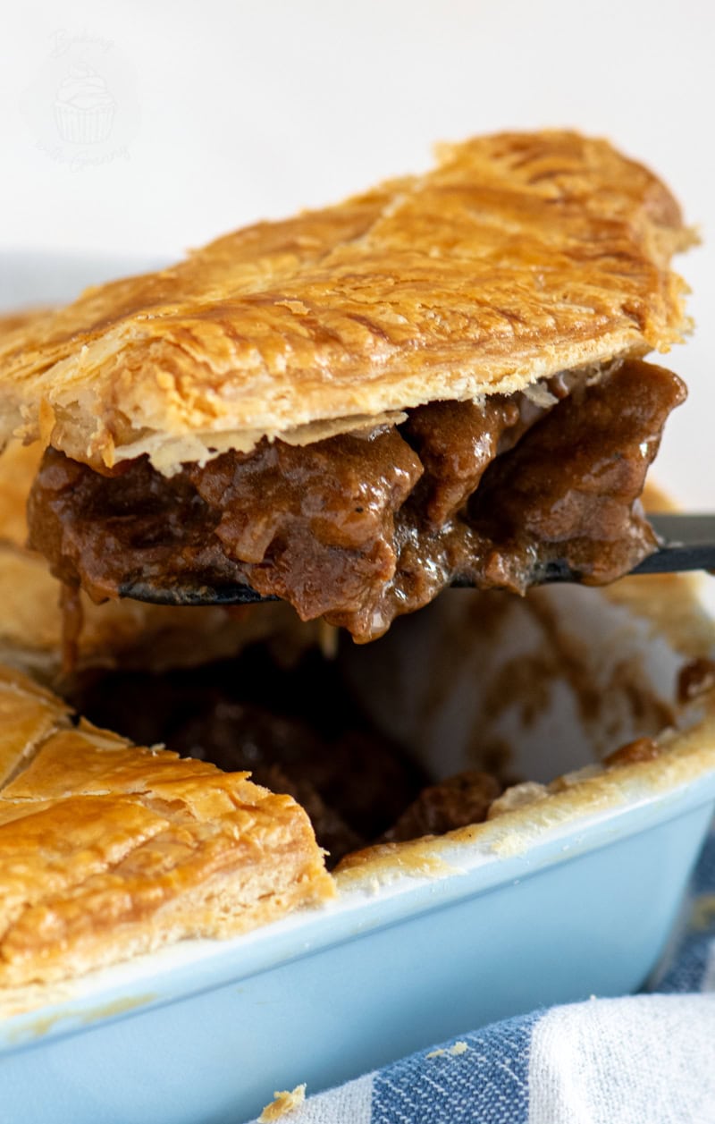 Classic Hogmanay steak pie with golden puff pastry and rich beef filling, served fresh from the oven.