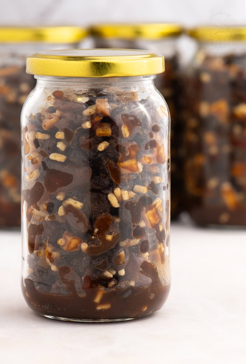 Sealed jar of homemade British Christmas mincemeat with golden lid, ready for making mince pies or gifting.
