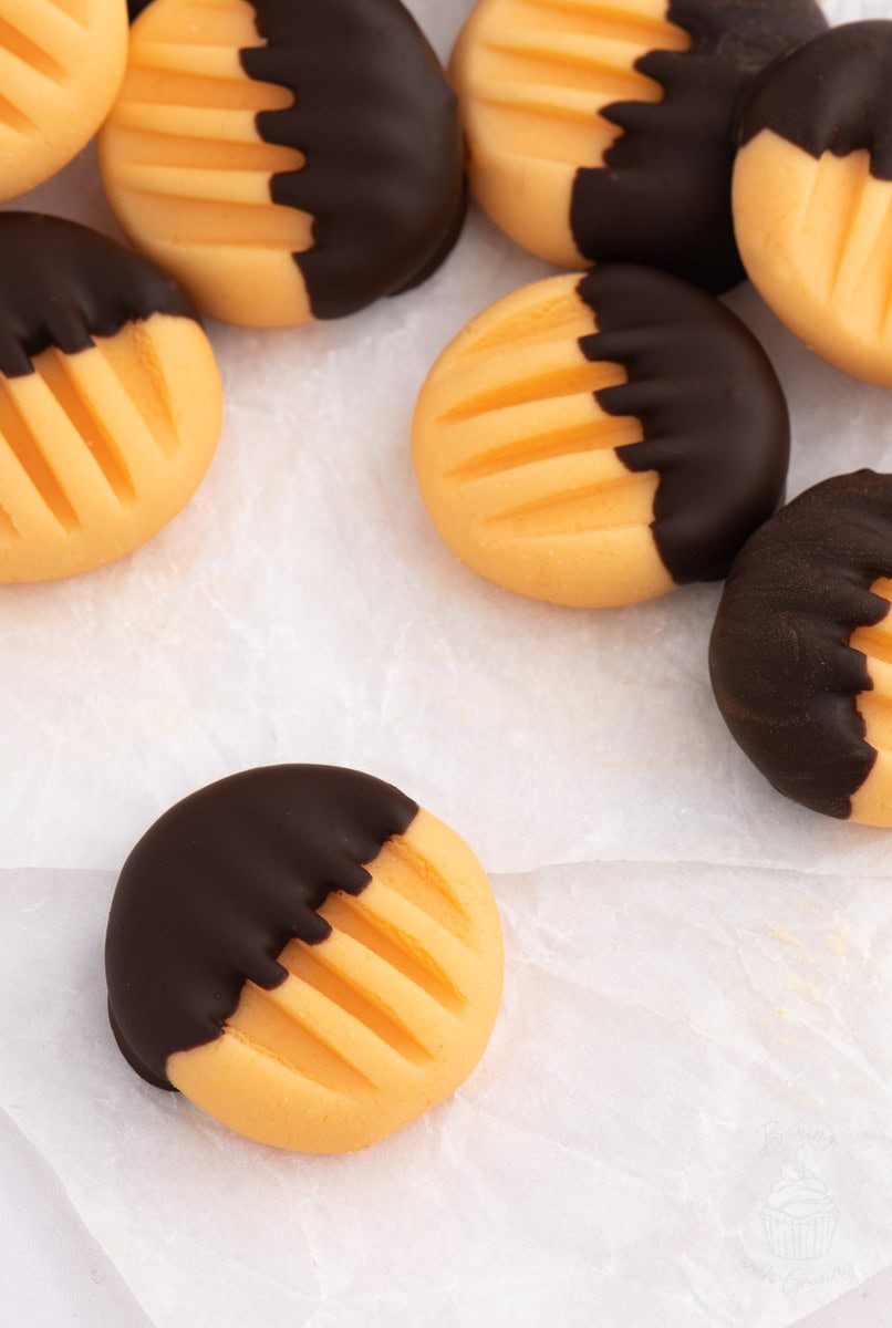 Orange creams with fork-pressed tops and dark chocolate dip, simple homemade Christmas sweets.