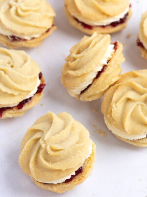 Selection of homemade Viennese Whirls biscuits with piped butter biscuit swirls sandwiched with jam and buttercream.