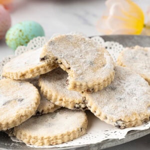 Close-up of Easter biscuits with a crumbly texture and currants, finished with a crisp sugar topping.