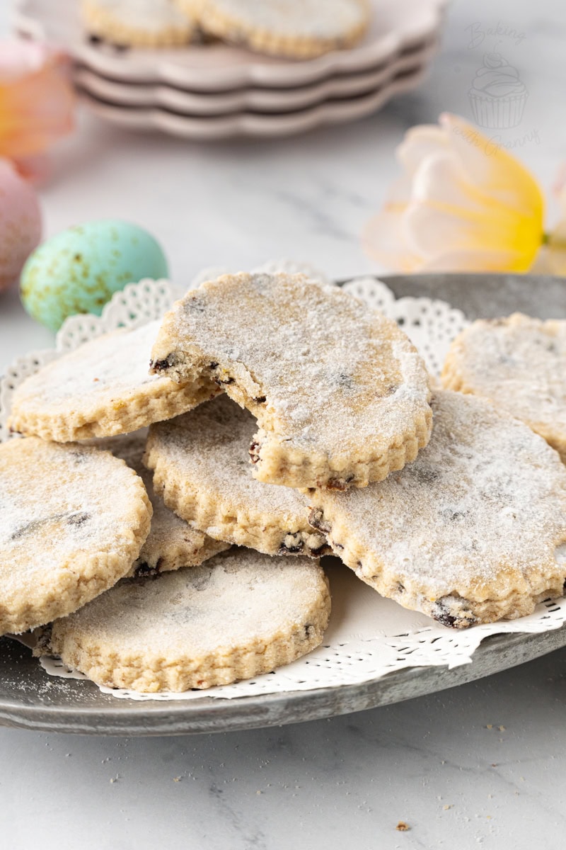 Close-up of Easter biscuits with a crumbly texture and currants, finished with a crisp sugar topping.