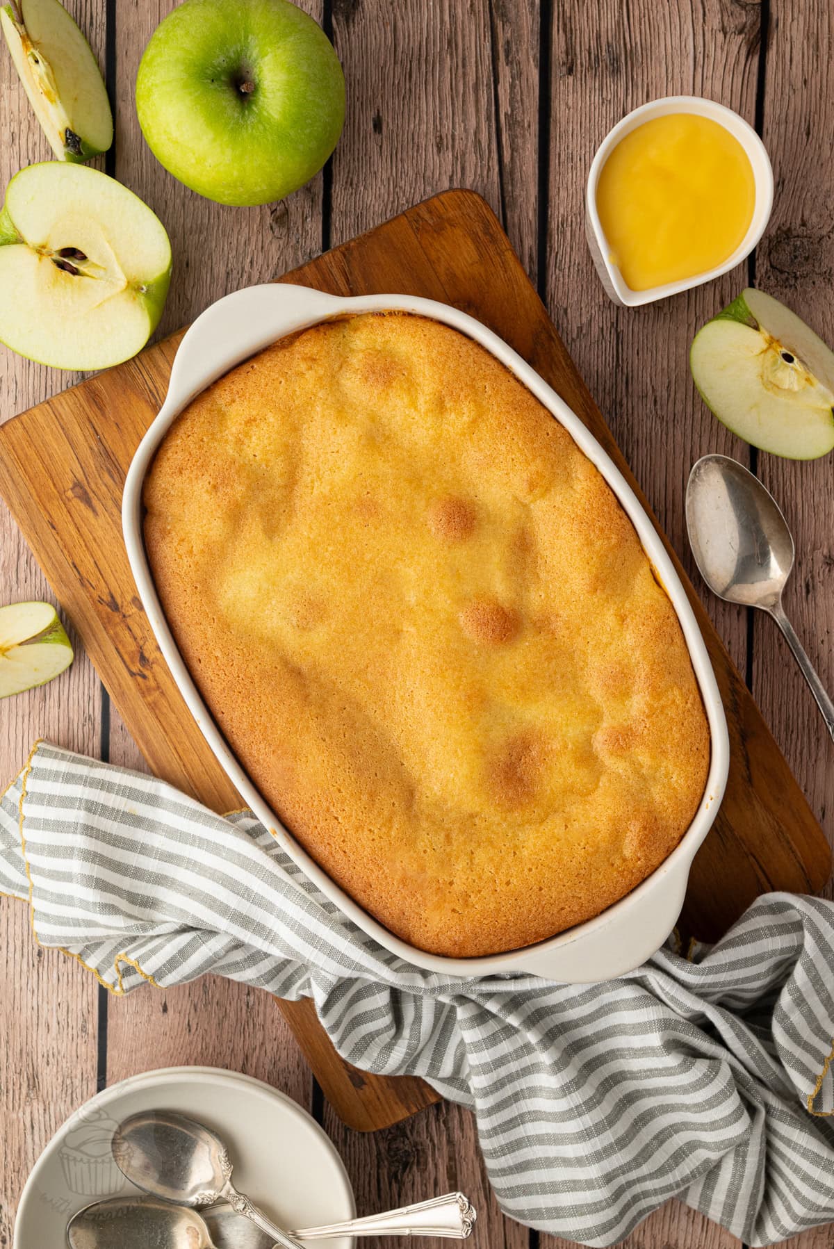 Eve’s Pudding with golden sponge in a white baking dish.