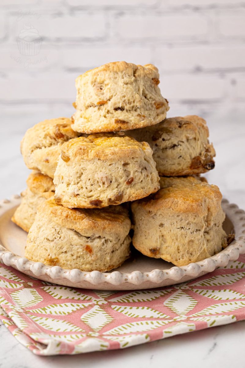 Freshly baked home made Fruit Scones on a white plate, perfect for a traditional afternoon tea.