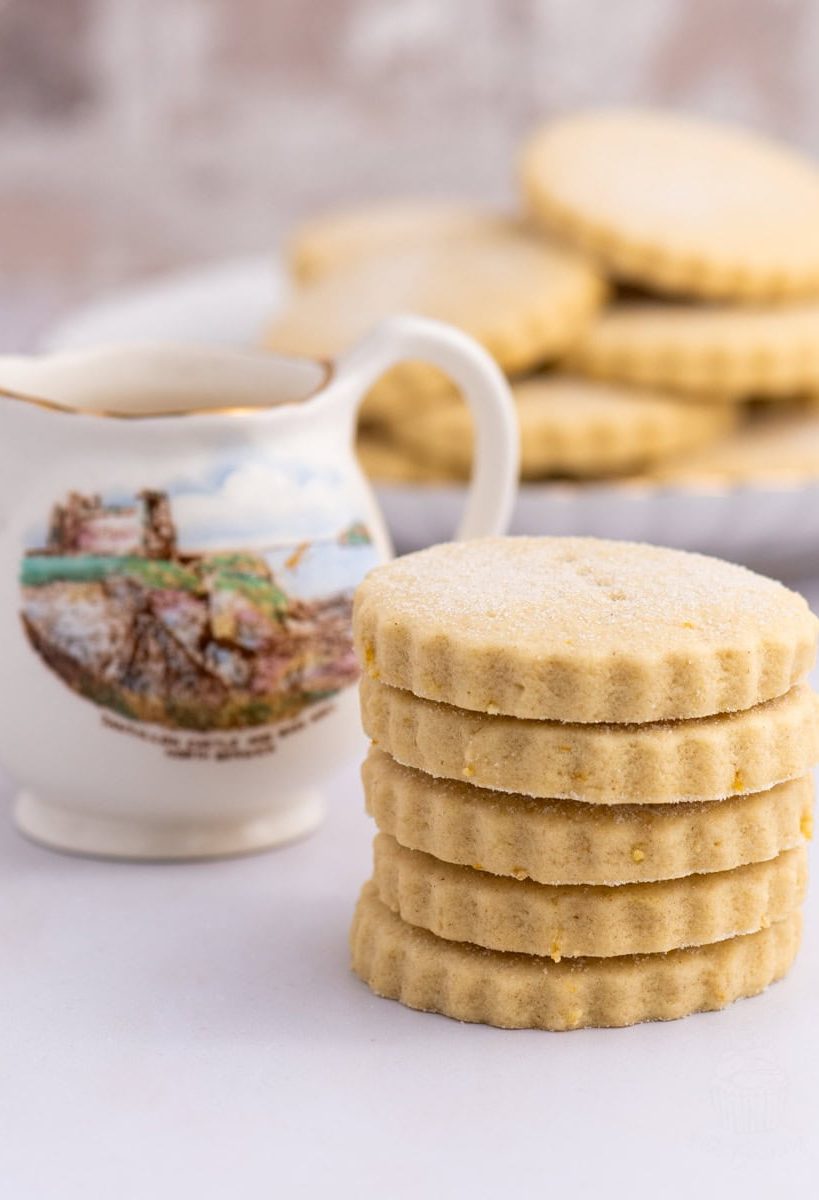 Stacked Tantallon Cakes biscuits with a jug showing Tantallon Castle in the background.
