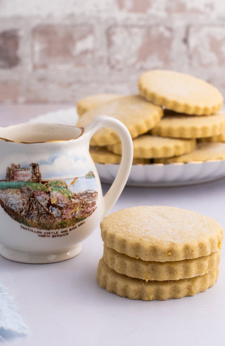 Traditional Tantallon Cakes biscuits stacked on a white surface with a Tantallon Castle jug.